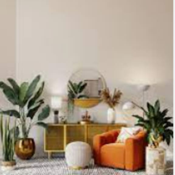 a living room filled with furniture and plants