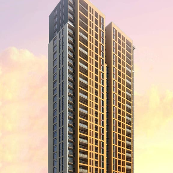 a tall building with many windows is surrounded by trees and other buildings.