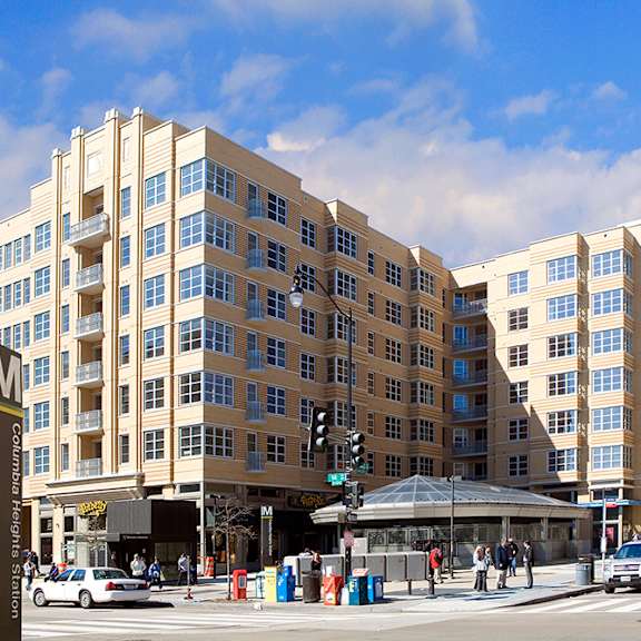 a rendering of a large apartment building on a city street