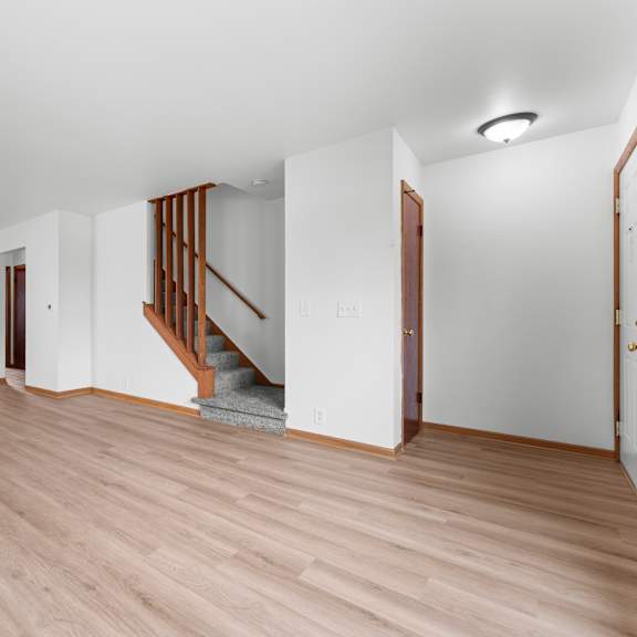 a room with a wooden floor and a ceiling fan.