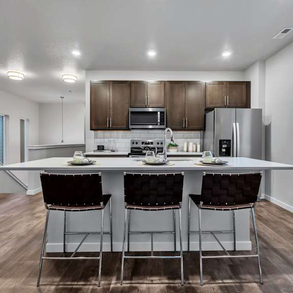 a modern kitchen with a dining table and chairs.