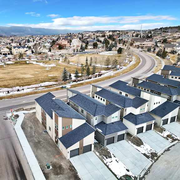 a road with a curve in the middle of a residential area.