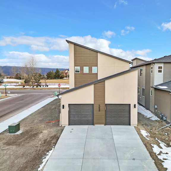 a row of houses with garages and driveways.