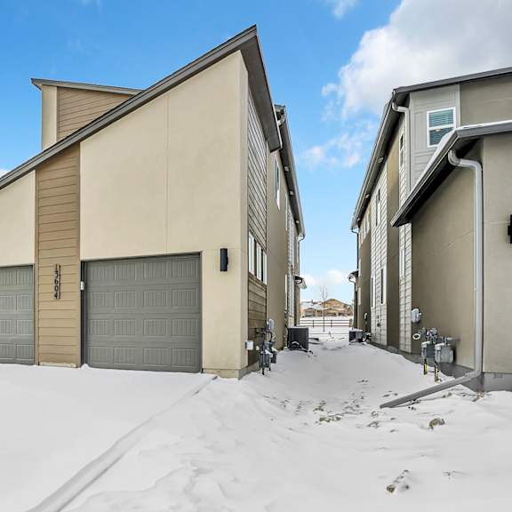 a house with a garage door in the snow.