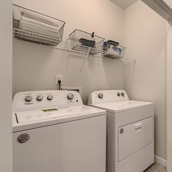 a washer and dryer in a laundry room with a door to a room