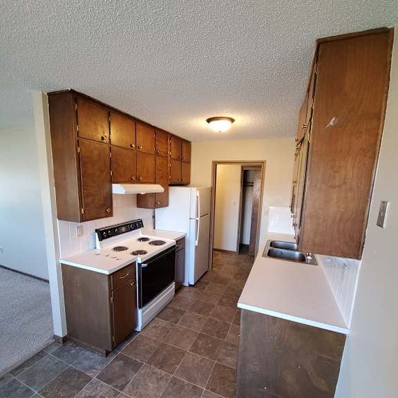 a view of the kitchen from the top of the stairs