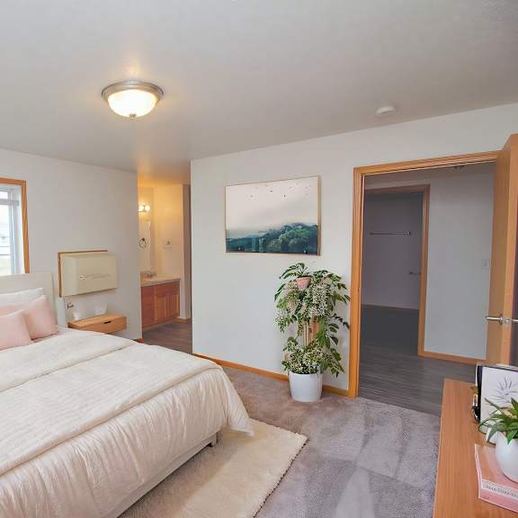 a bedroom with a large bed and a window.