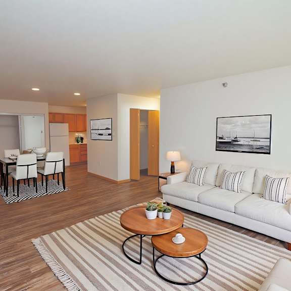 a living room with a white couch and a coffee table.