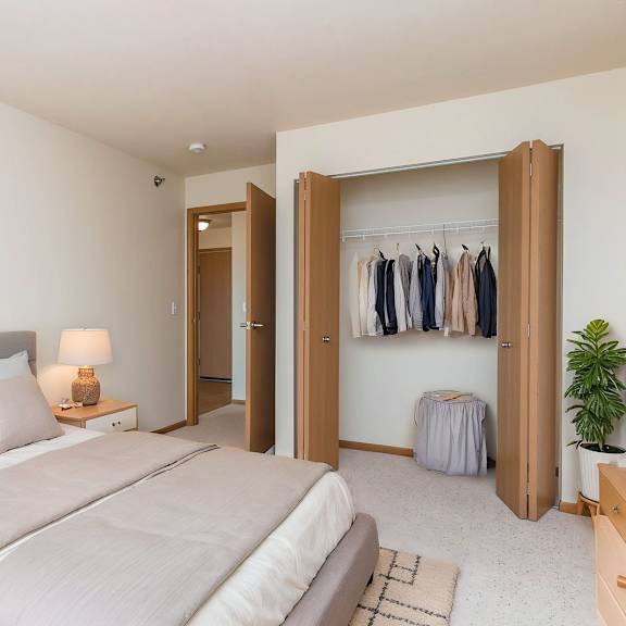a bedroom with a large bed and a wardrobe.