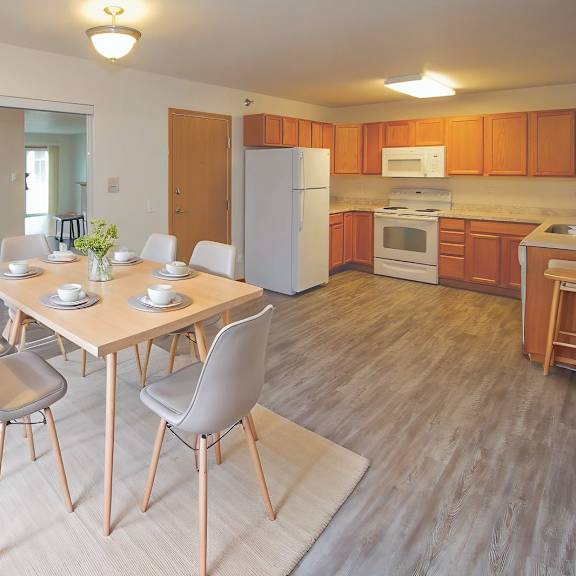 a kitchen with a dining table and chairs.