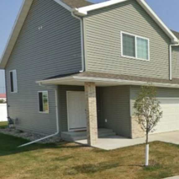 a row of houses with garages and driveways.