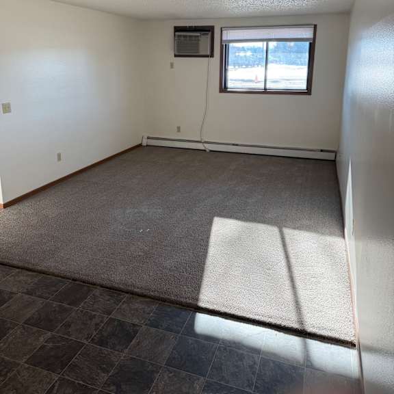 a room with a window and a tiled wall.