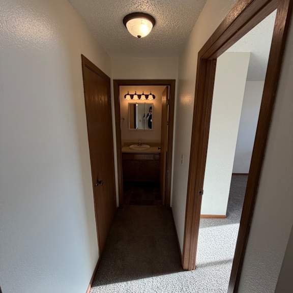 a room with a skylight and a small mirror on the wall.