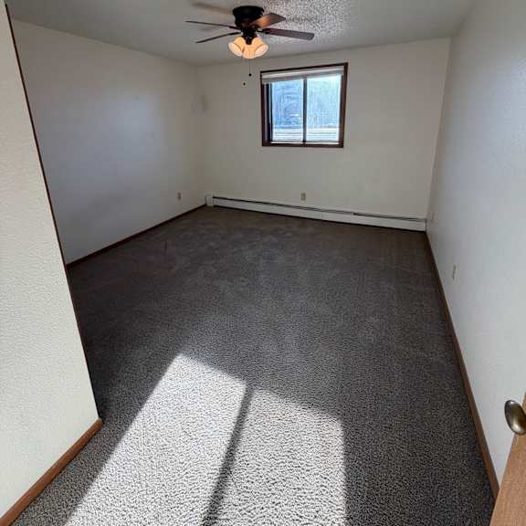 a room with a window and a ceiling fan.