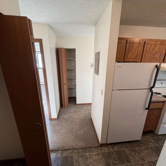 a kitchen with a stove top oven and a window.