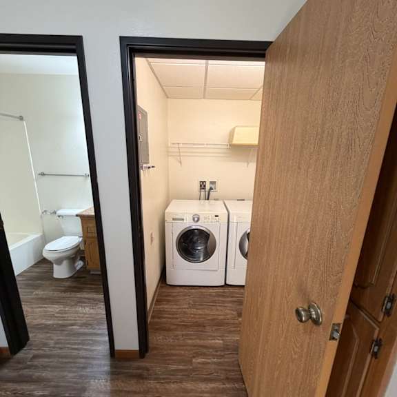 a washing machine is installed under a mirror.