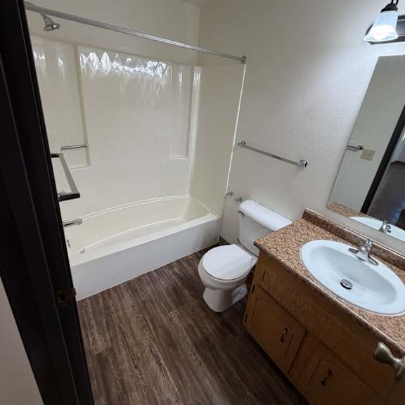 a bathroom with a sink, mirror, and a walk-in shower.
