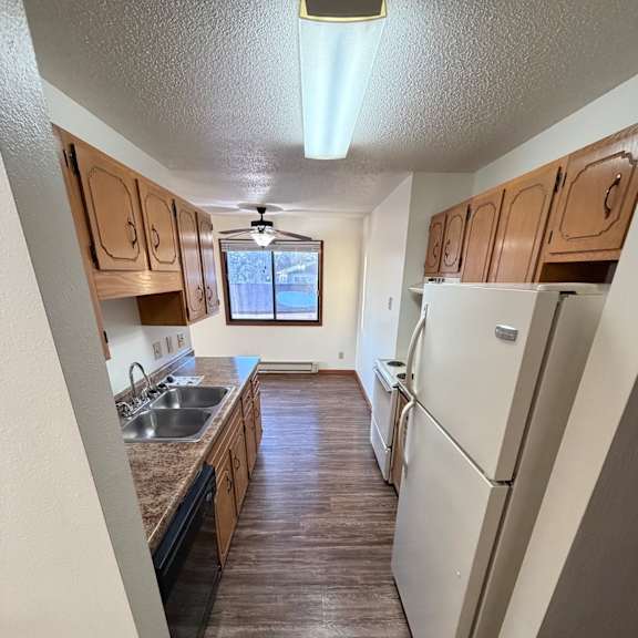 a kitchen with a stove top oven and a window.