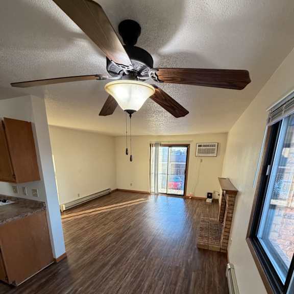 a ceiling fan with a light is mounted on a wall in a room with wooden walls and a skylight.