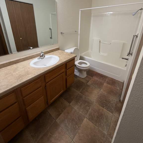 a bathroom with a shower and toilet.