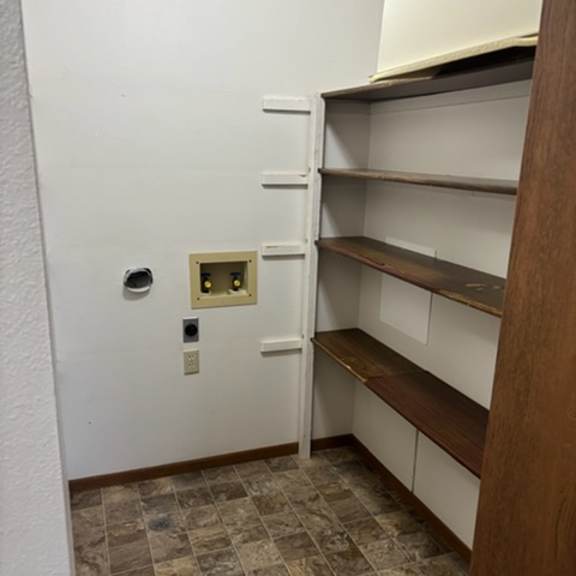a white door with a small square window in the middle.