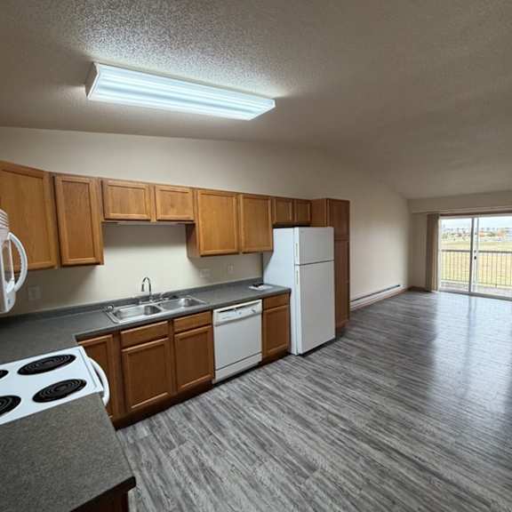 a kitchen with wooden cabinets and a white refrigerator.