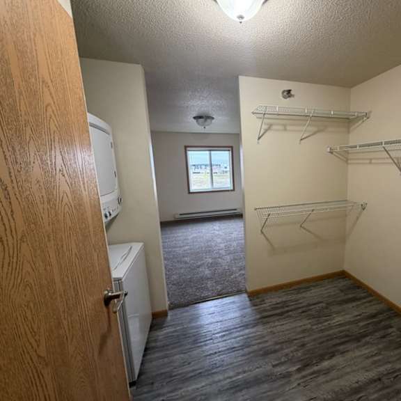 a room with a door on the left and a window in the middle.