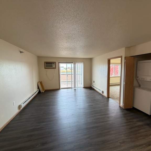 a spacious room with wooden floors and a white ceiling.