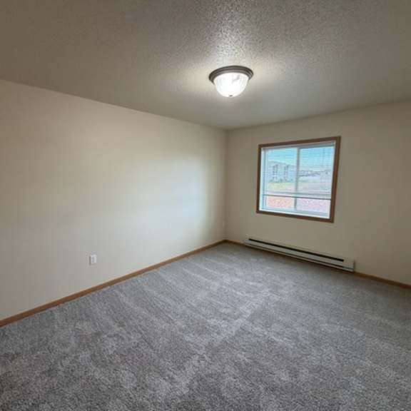 a room with a carpeted floor and a window.