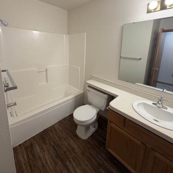 a white toilet sits in a bathroom next to a sink.