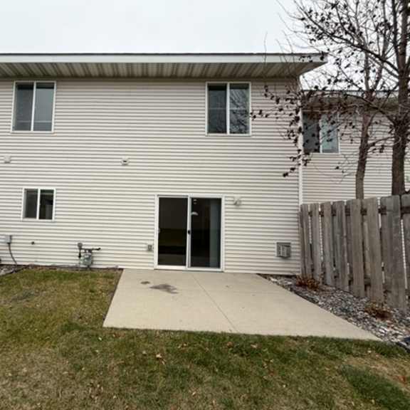 a house with a grey siding and a white door.