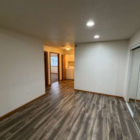 a room with wooden flooring and a glass door.