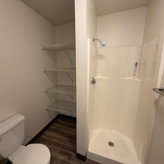 a white toilet is next to a white sink in a small bathroom.