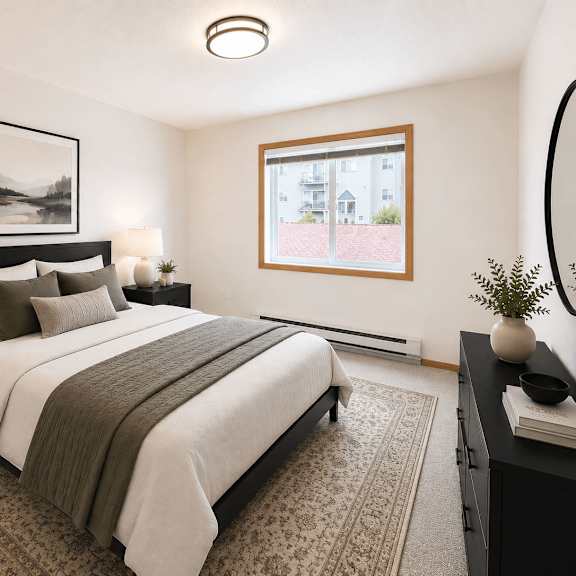 a bedroom with a large bed and a framed picture on the wall.