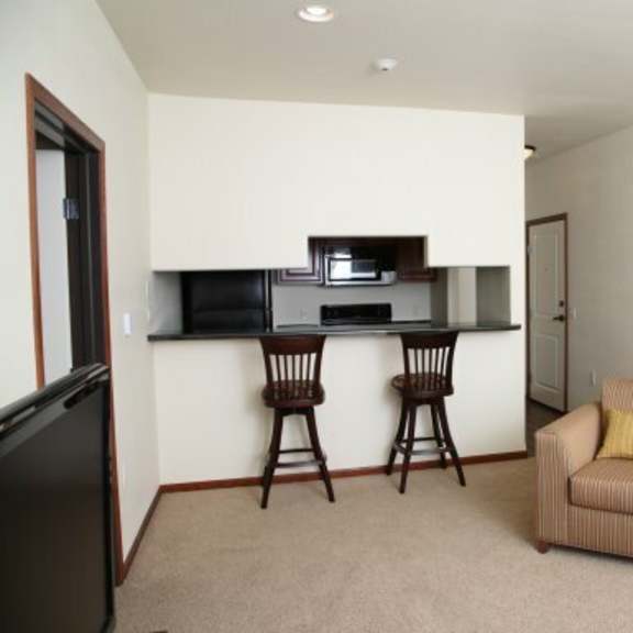 a living room with a couch, chairs, and a television.