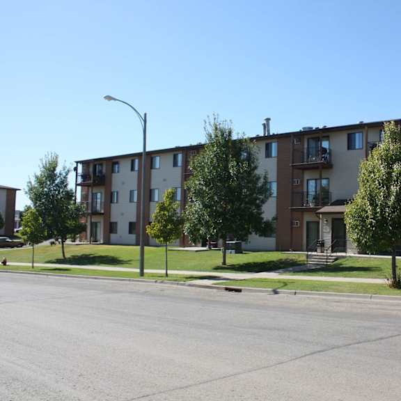 apartment building with a tree in front of it.