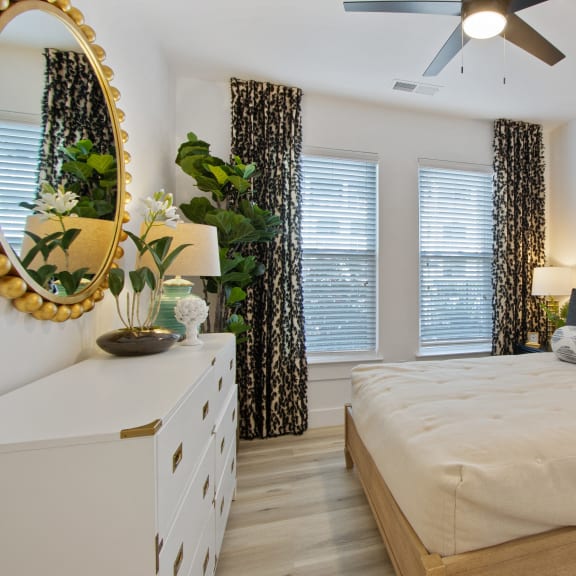 a bedroom with a large bed and a ceiling fan