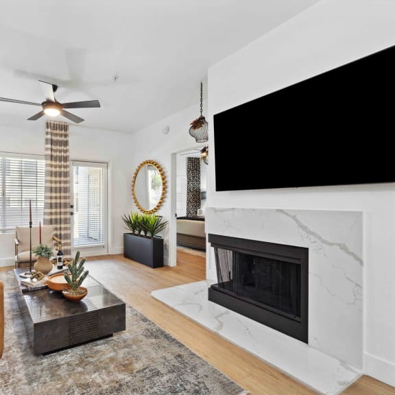 a living room with a fireplace and a large tv above it