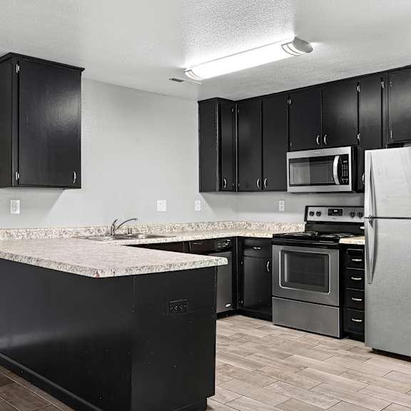 Kitchen with a counter and cabinets. at OSM Properties Homes & Apartments, Chico, California