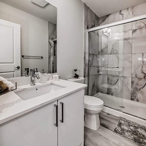 a bathroom with a shower toilet and sink