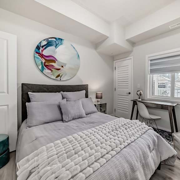 a bedroom with a large bed and a window