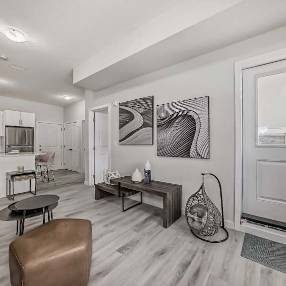 a living room with a door to a kitchen and a dining room