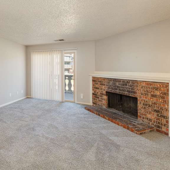 a room with a fireplace and a sliding glass door.