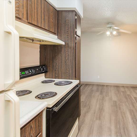a kitchen with a white stove top oven and a white counter top.
