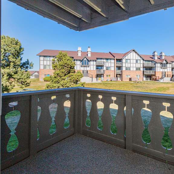 a balcony with a railing that has hourglass designs on it.