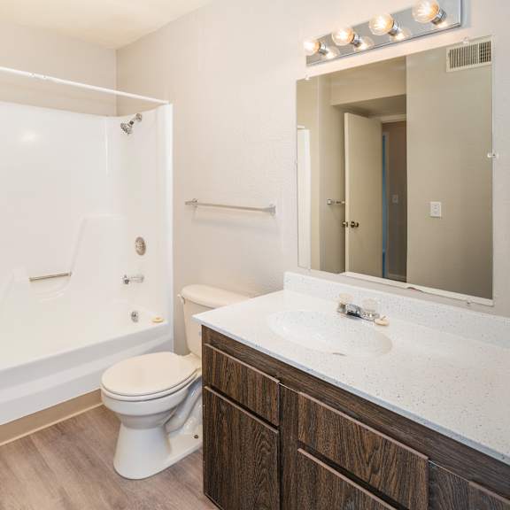a white toilet sits in a bathroom next to a sink.