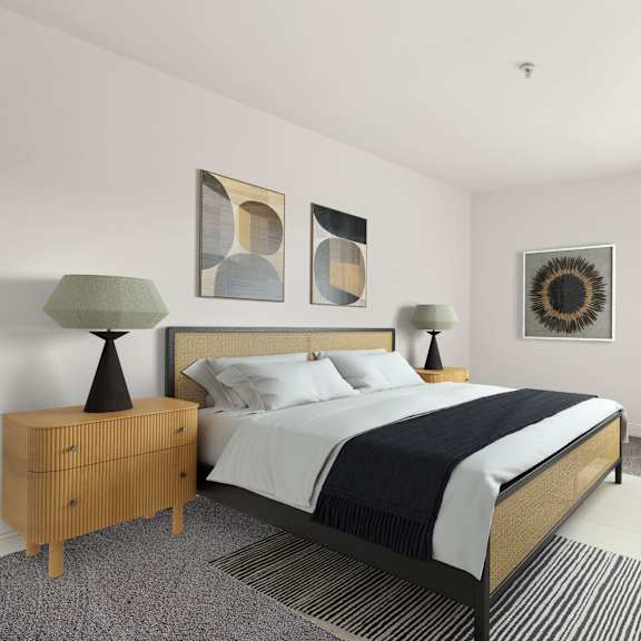 a bedroom with a bed, nightstand, and lamp.