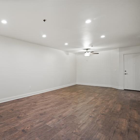 empty room with wooden floor and white walls.