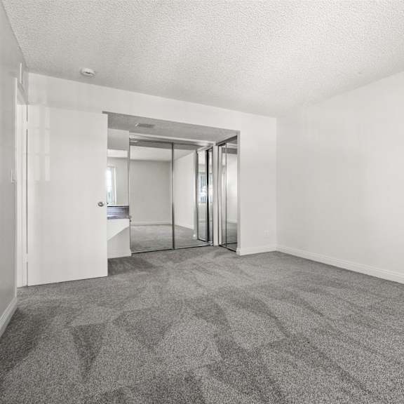 a room with a carpeted floor and a glass door.