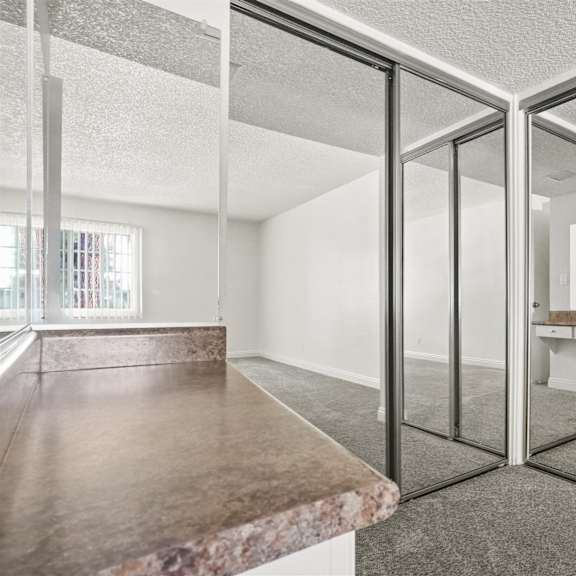 a room with a marble countertop and a glass door.